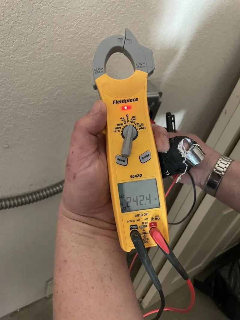 Voltage testing with clamp meter during Electrical Installation Services in Opp